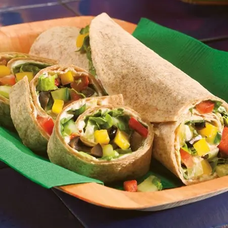 Breakfast burrito filled with scrambled eggs, black beans, and bell peppers, served on a plate