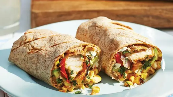 Grilled chicken burrito wrapped in whole wheat tortilla, filled with mixed vegetables and corn