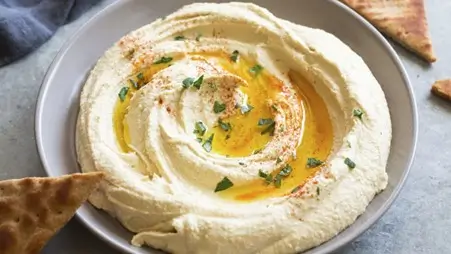 smooth-classic-hummus-dip-topped-with-olive-oil-herbs-and-middle-eastern-spices